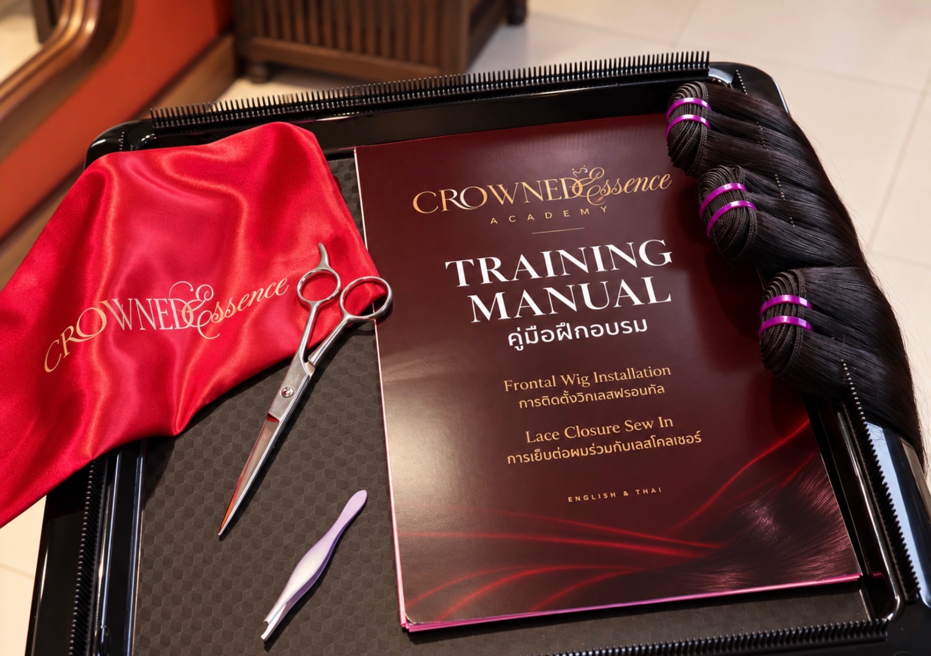 Crowned Essence Academy training manual, shears and raw hair bundles