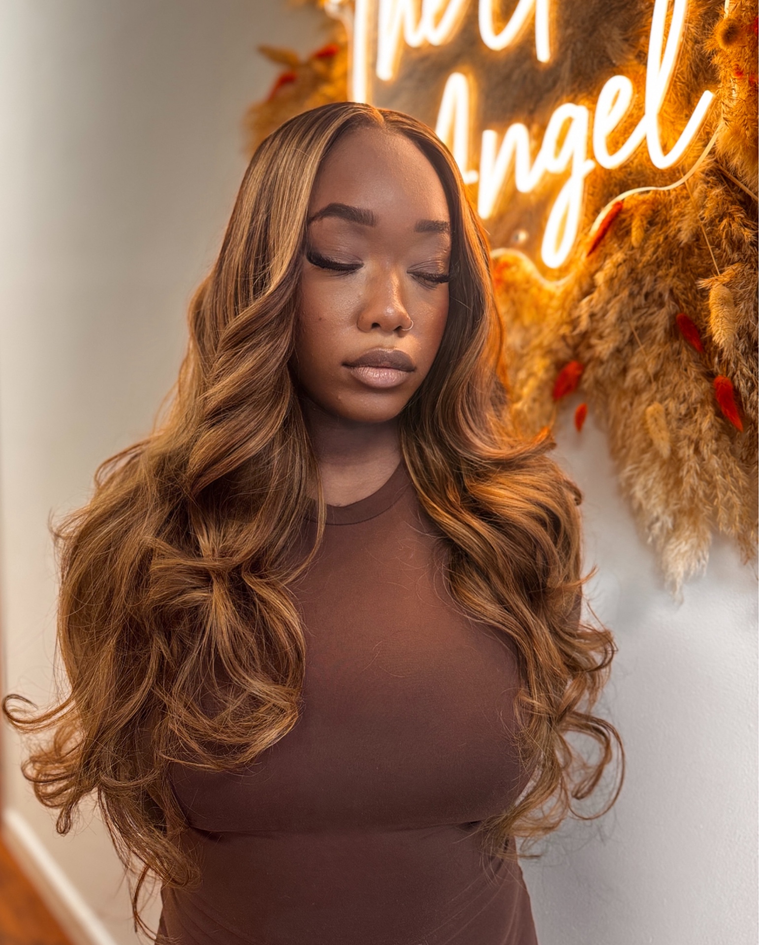 Crowned Essence client install — caramel honey highlights in soft body waves